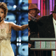 (L-R): Whitney Houston performs during the 2004 World Music Awards on Sept. 15, 2004, in Las Vegas, Nev.; Notorious B.I.G., who won rap artist and rap single of the year, at the podium during the annual Billboard Music Awards in New York, in Dec. 6, 1995.